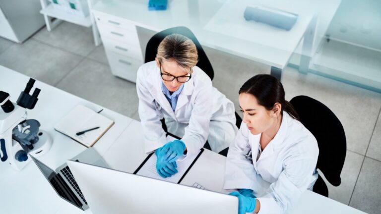 how early safety pharmacology studies accelerate drug development and reduce risk 4 Wuxi Lab Scientists At Laboratory Desk